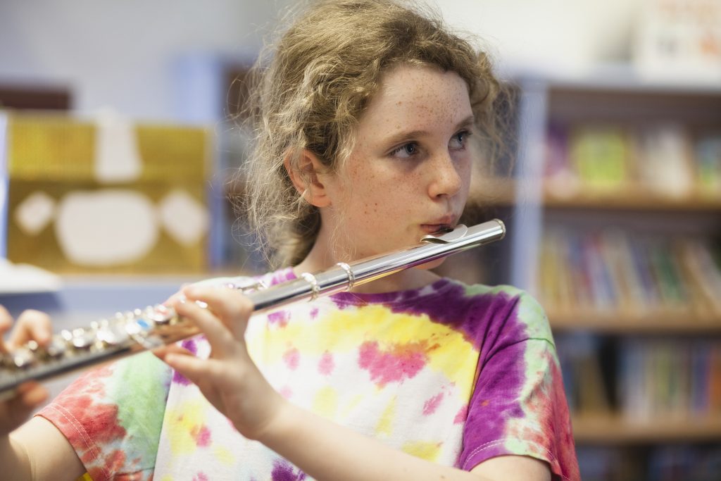 Photo of a girl practising the flute.