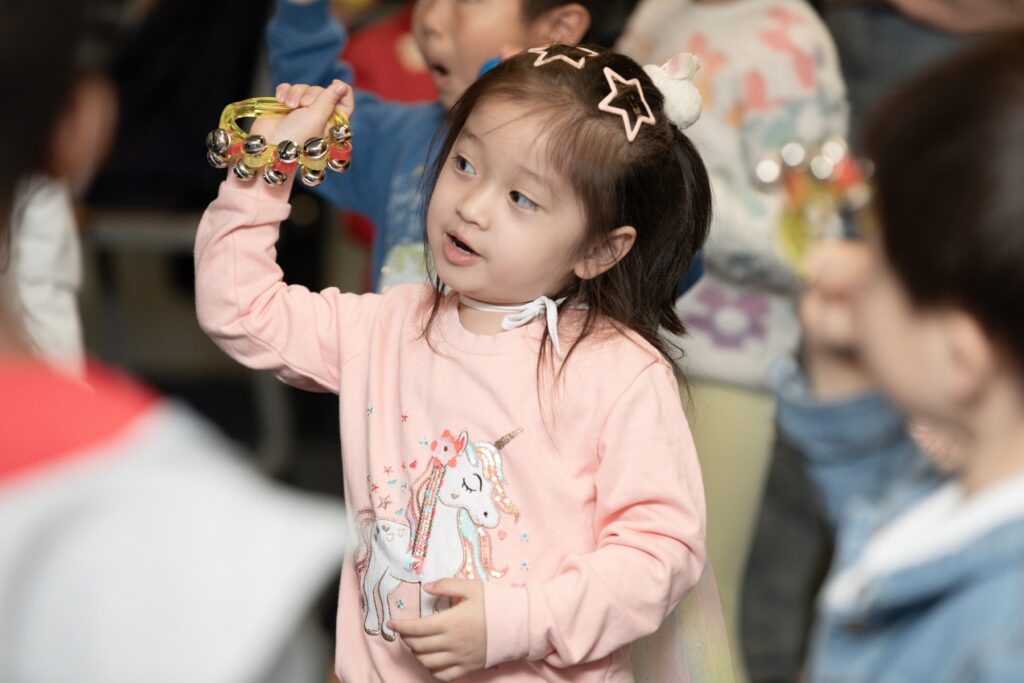 Photo of a girl with a shaker in her hand at a Step Into Music class