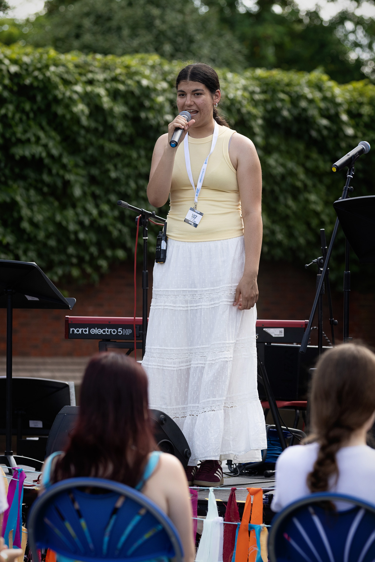 A Youth Council member on stage addressing the crowd at the Lift Off festival.