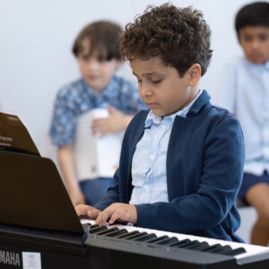 A boy playing the keyboard.