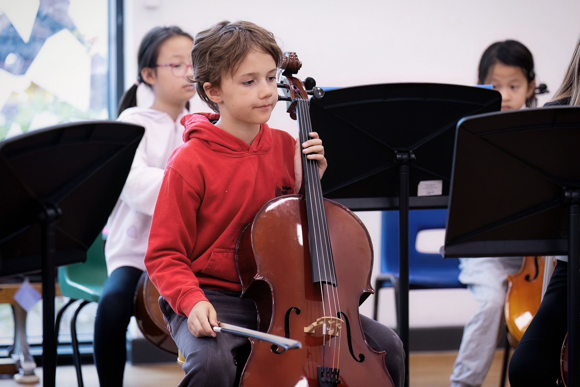 A young cellist during a string ensemble rehearsal.