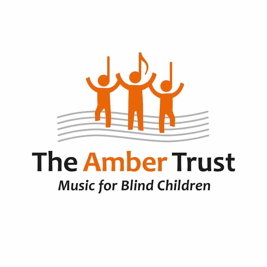 Logo for The Amber Trust shows three orange stick figures with music notes above their heads, standing on horizontal lines representing a musical stave, symbolising inclusion. Text below reads The Amber Trust — Music for Blind Children.