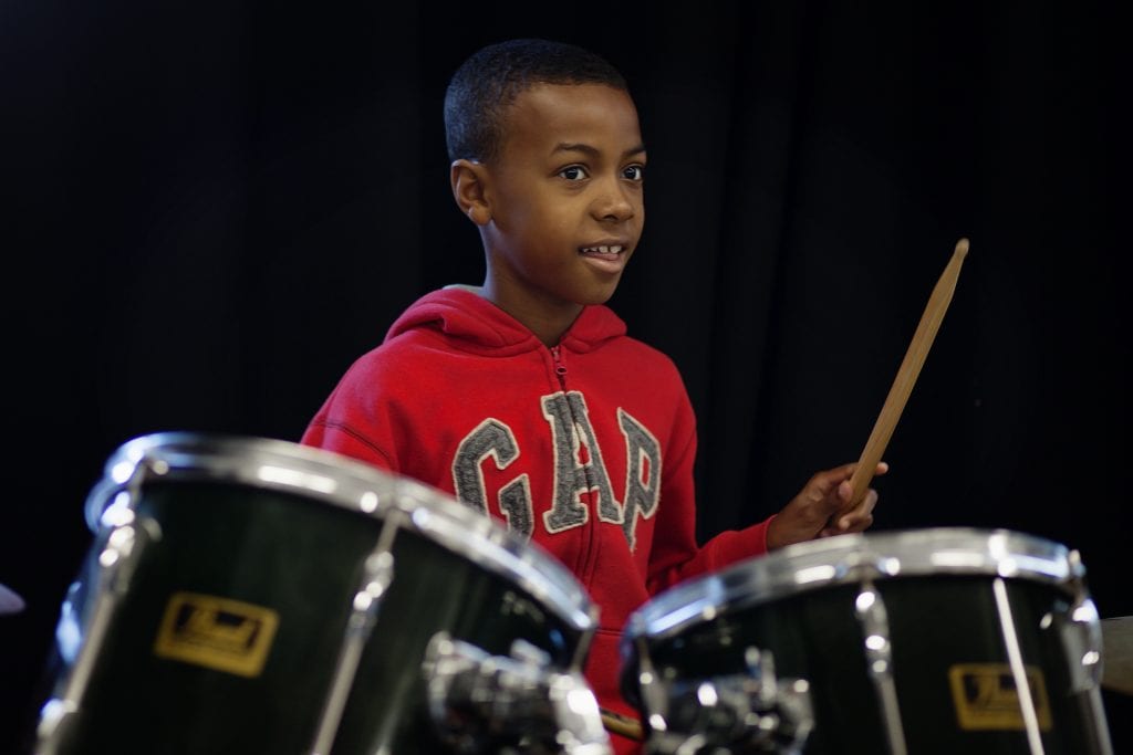 A boy playing the drums