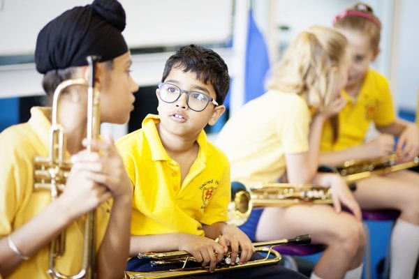 Children having a trumpet lesson in school.