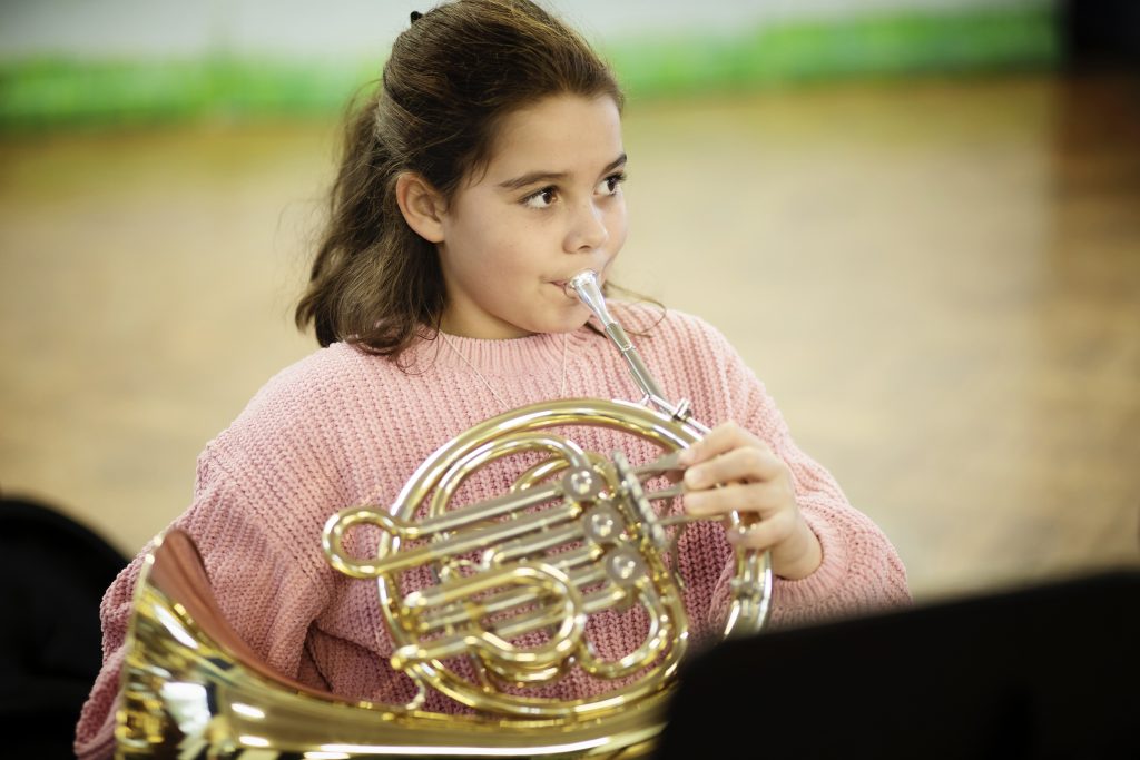 Photo of girl playing French horn