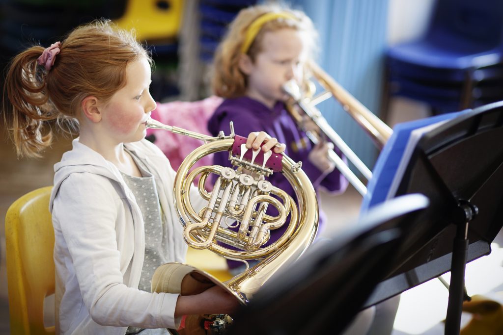 Children playing brass instruments in a junior Merton Music Foundation band